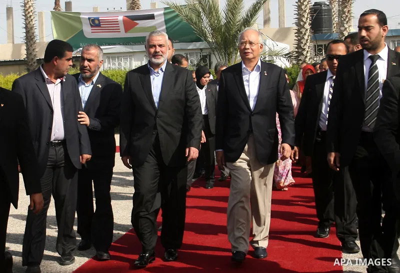 Palestinian Prime Minister in Gaza strip, Ismail Haniyeh, receives Malaysian Prime Minister Mohammed Najib, upon his arrival in the southern Gaza Strip town of Rafah through the border with Egypt, on January 22, 2013. Ph...