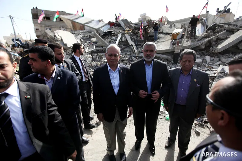 Malaysian Prime Minister Najib Razak, visits a government office destroyed in Israel's recent offensive on Gaza, in Gaza City Tuesday, Jan. 22, 2013. During his first-ever visit to the territory Tuesday, Najib Razak is m...