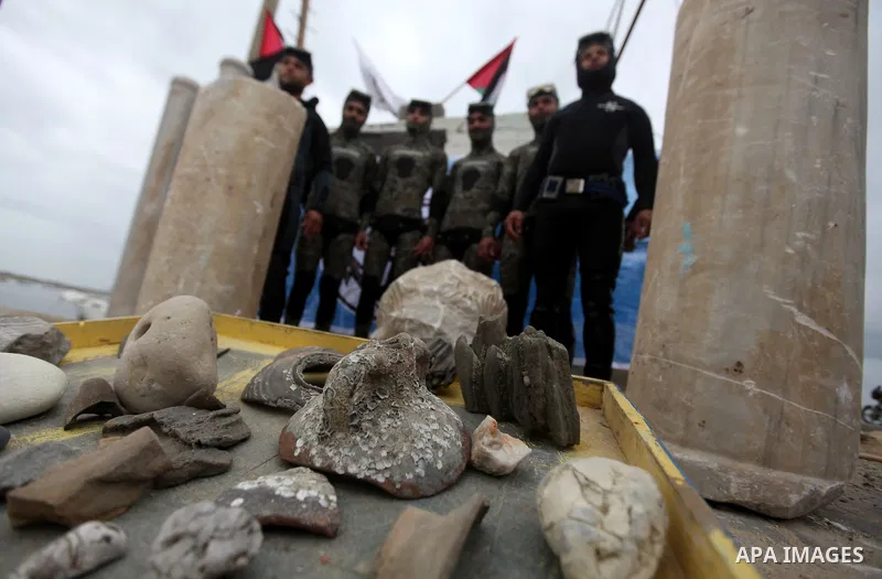 Members of Palestinian naval policemen extract an ancient columns older than 1300 years in the port of Gaza City on Jan. 23, 2013. Photo by Majdi Fathi
