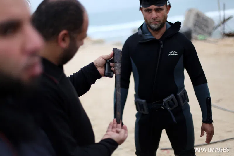 Members of Palestinian naval policemen preparing themselves to extract an ancient columns and pieces of pottery older than 1000 years in the port of Gaza City on Jan. 23, 2013. Photo by Majdi Fathi