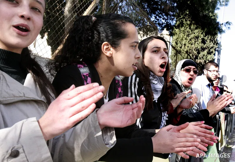 Palestinians take part in a protest against the opening project of the street number (4) in the middle of Bet Sfafa neighbourhood, which is for settlement project services, in front of Jerusalem municipality, in Jerusale...