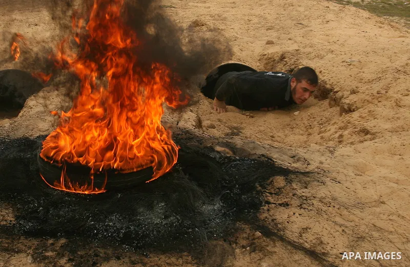 Palestinian youths display their skills during scouts training in Rafah southern Gaza strip, on January 23, 2013. Palestinian ministry of education and higher education organized a camp to train Palestinian boy scouts fo...