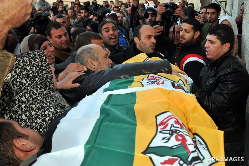 Palestinians carry the body of Lubna Hanash during her funeral in the West Bank town of Bethlehem January 23, 2013. Israeli soldiers shot and killed Hanash, a 21-year-old Palestinian woman, near Hebron on Wednesday and w...