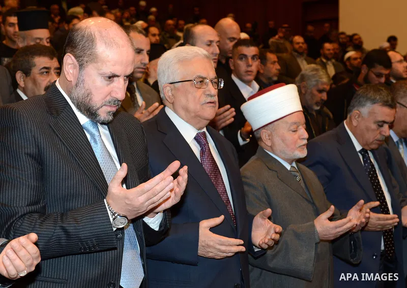 Palestinian President Mahmoud Abbas (c) attends a ceremony commemorating the birth of Prophet Mohammed, known in Arabic as "Mawlid al-Nabawi", in the West Bank city of Ramallah on January 24, 2013. Photo by Thaer Ganaim