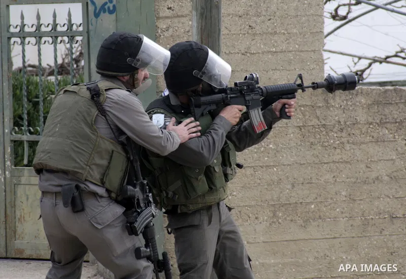 Israeli soldiers fire tear gas towards Palestinian protesters during a protest against the expropriation of Palestinian land by Israel on January 25, 2013 in the village of Kafr Qadum, near Nablus, in the occupied West B...
