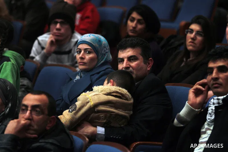 Palestinians watch the film of "5 Broken Cameras" in the West Bank city of Ramallah on January 29, 2013. The film 5 Broken Cameras was nominated for the 2013 Best Documentary Feature Oscar award. The film tells the story...