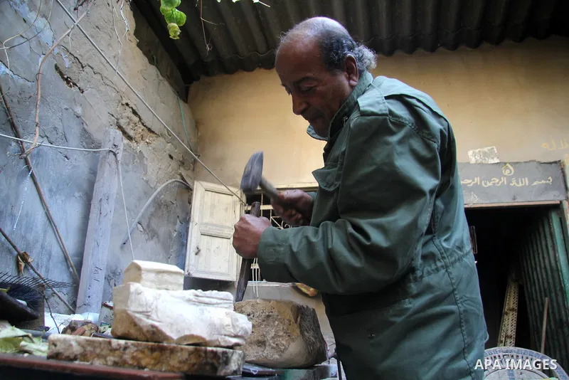 Palestinian artist Abdul Latif abu Karsh, 63 years, sculpts a rock in a workshop in his house at al-Shati refugee camp in Gaza city on January 30, 2013. Abu Karsh stints several arts like rock sculpture, wood burning art...