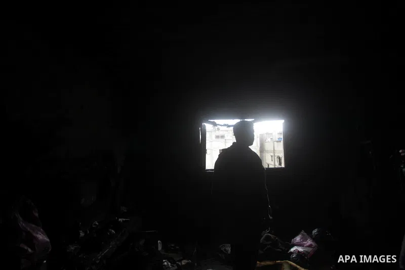 Palestinians inspect the damage in the bedroom to the Dhuheir family have led to six deaths after a fire from a candle that swept through their home in Shijaia in the east Gaza city on Jan. 31, 2013 The Dhuheir family wa...