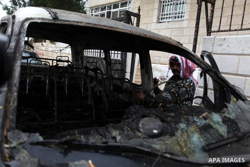 A Palestinian man inspects a burnt vehicle following an apparent price tag attack by Jewish settlers in the West Bank village of Deir Jarir, northeast of Ramallah, on February 5, 2013. Suspected Jewish extremists torched...