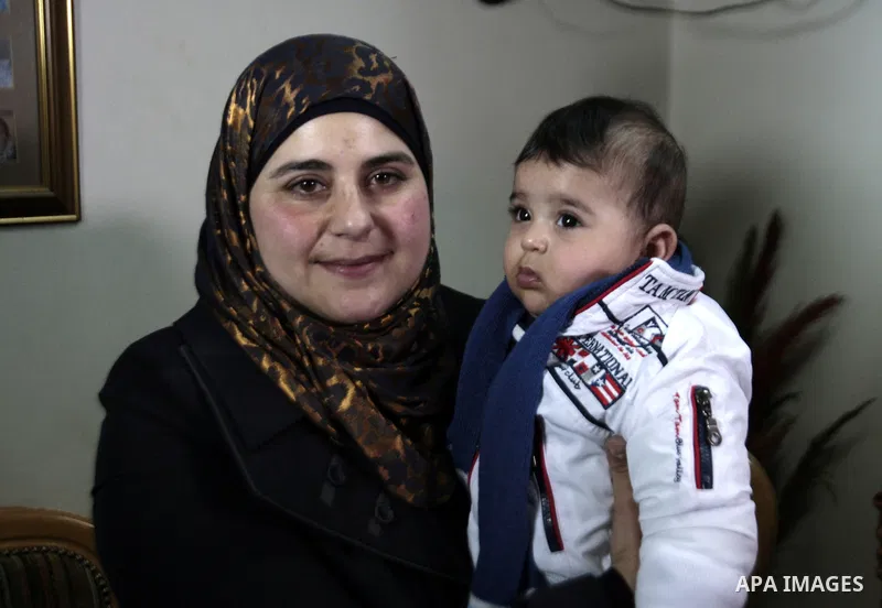 Dallal Ziben, 32, carries her baby muhannad as she attends a press conference to announce for the succes artificial insemination operations after smuggling sperm samples from four Palestinian prisoners, in the West Bank...