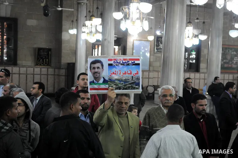An Egyptian supporter of Iranian President Mahmoud Ahmadinejad hold a banner reads in Arabic "Welcome to Cairo" upon his arrival for a visit to al-Hussein mosque in Cairo on February 5, 2013. Ahmadinejad held talks in Ca...