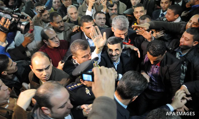 Iranian President Mahmoud Ahmadinejad greets supporters upon his arrival for a visit to al-Hussein mosque in Cairo on February 5, 2013. Ahmadinejad held talks in Cairo on the divisive issue of Syria's war, as he kicked o...