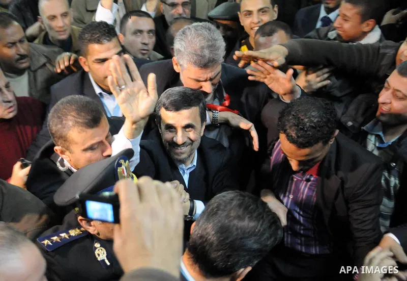Iranian President Mahmoud Ahmadinejad greets supporters upon his arrival for a visit to al-Hussein mosque in Cairo on February 5, 2013. Ahmadinejad held talks in Cairo on the divisive issue of Syria's war, as he kicked o...