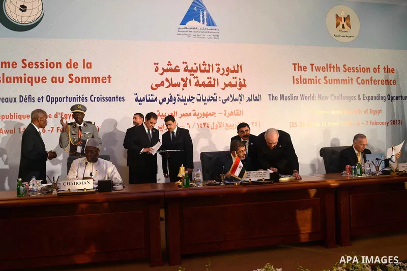 Egyptian President Mohammed Morsi (C) sits amidst officials as he attends the 12th summit of the Organisation of Islamic Cooperation on February 6, 2013 in Cairo. The 12th summit of the Organisation of Islamic Cooperatio...