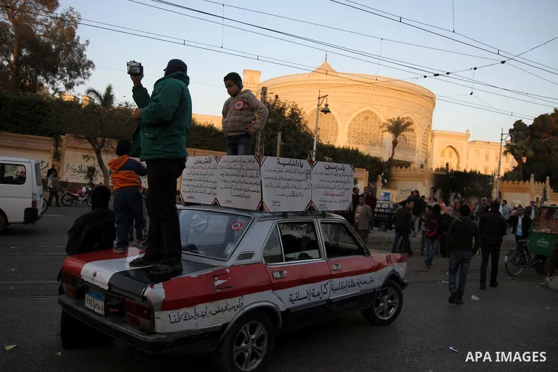 Egyptian anti-government protestors shout political slogans as they wave their national flag and banners during a march towards Cairo's landmark Tahrir square during a demonstration against Egypt's President Mohamed Mors...