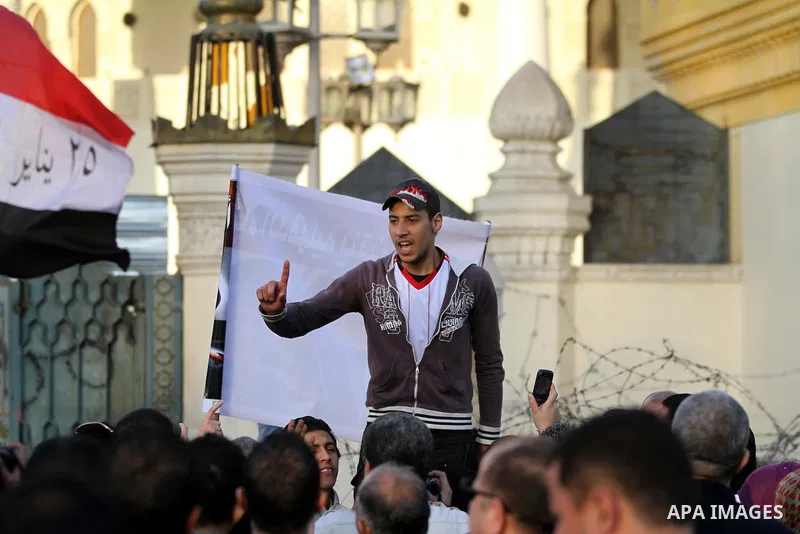 Egyptian anti-government protestors shout political slogans as they wave their national flag and banners during a march towards Cairo's landmark Tahrir square during a demonstration against Egypt's President Mohamed Mors...