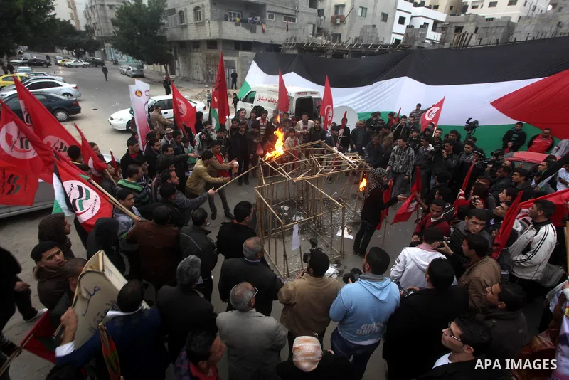 Palestinian supporters of Palestinian People's Party burn a symbolic jail during a demonstration in solidarity with hunger-striking Palestinian prisoners held by Israel, demanding their release in Gaza city on Feb, 10, 2...