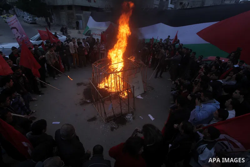 Palestinian supporters of Palestinian People's Party burn a symbolic jail during a demonstration in solidarity with hunger-striking Palestinian prisoners held by Israel, demanding their release in Gaza city on Feb, 10, 2...