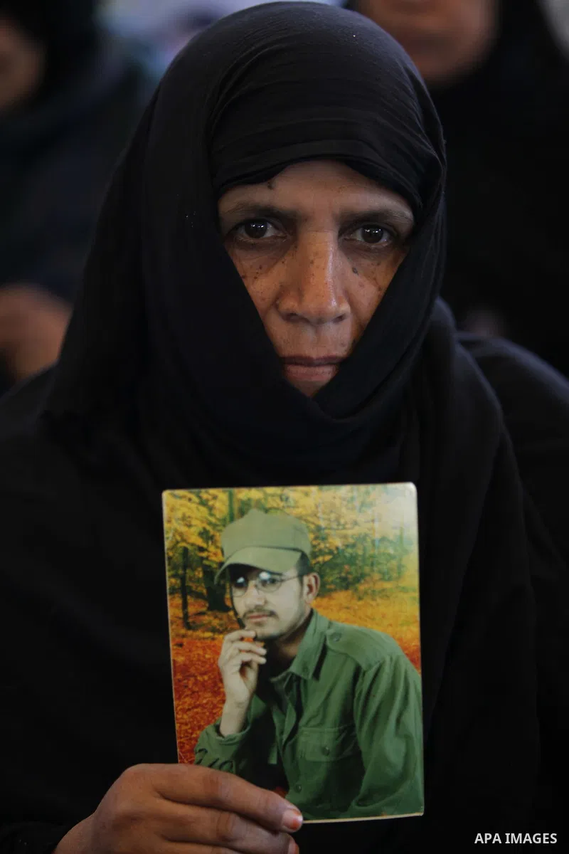 Palestinian women hold pictures of prisoners held in the Israeli jails during a protest calling for the release of Palestinian prisoners from Israeli jails in front of the Red cross office in Gaza city, Feb. 11, 2013. Ph...