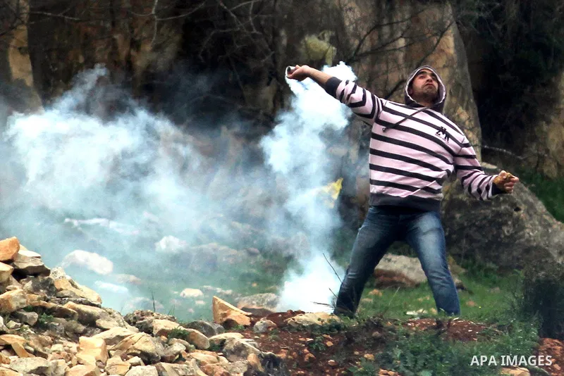 A Palestinian student from the University throw back a tear gas canister towards Israeli security forces during clashes with Israeli security forces following a demonstration in support of Palestinian prisoners on hunger...