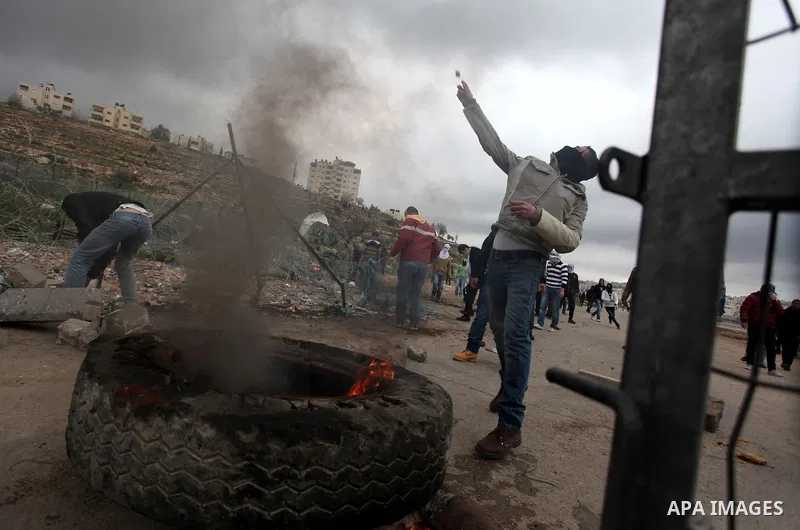 Palestinian students from the University of Birzeit throw stones towards Israeli security forces during clashes following a demonstration in support of Palestinian prisoners on hunger strike in Israeli jails, outside Isr...