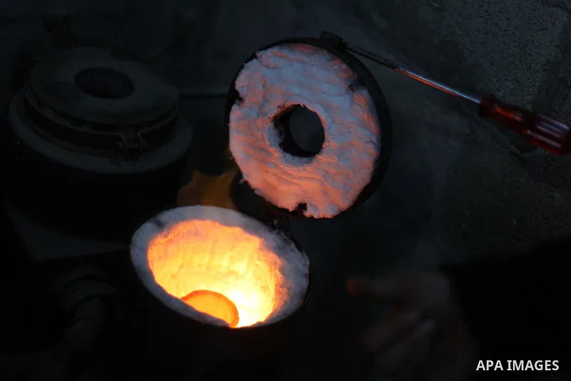 A Palestinian jeweller melts gold at his workshop in Gaza city on February 18, 2013. Photo by Ashraf Amra