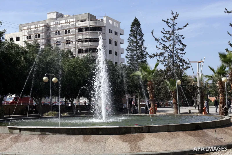 Palestinians walk at a park during a sunny day in Gaza city on February 21, 2013. Photo by Ashraf Amra