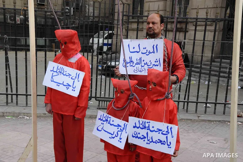 Egyptian protesters carry placards during an anti-government demonstration against the government of President Morsi, in front of High Court, in Cairo, Egypt, 22 February 2013. The opposition accuses Morsi, Egypt's first...