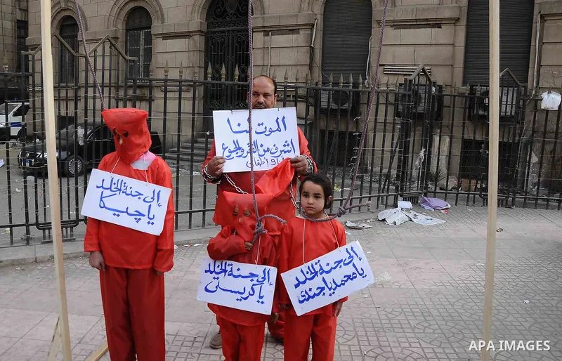 Egyptian protesters carry placards during an anti-government demonstration against the government of President Morsi, in front of High Court, in Cairo, Egypt, 22 February 2013. The opposition accuses Morsi, Egypt's first...