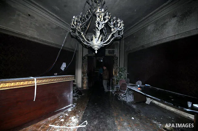 A picture shows the charred remains of Egyptian laywer Ayman Nur's office, chairman of the Ghad El-Thawra Party, after members of the Black Bloc group torched his office in downtown Cairo on February 22, 2013. Photo by T...