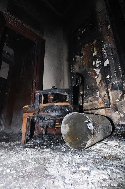 A picture shows the charred remains of Egyptian laywer Ayman Nur's office, chairman of the Ghad El-Thawra Party, after members of the Black Bloc group torched his office in downtown Cairo on February 22, 2013. Photo by T...