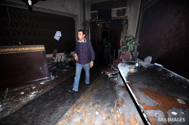 Egyptians inspect the destruction after members of the Black Bloc group torched office tomorrow El- thour party in downtown Cairo on February 22, 2013. Photo by Tareq Gabas