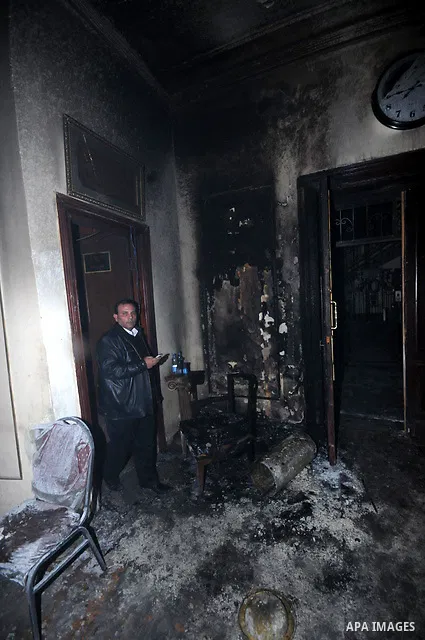 Egyptians inspect the destruction after members of the Black Bloc group torched office tomorrow El- thour party in downtown Cairo on February 22, 2013. Photo by Tareq Gabas