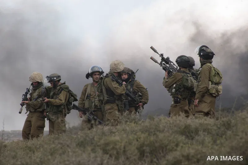 An Israeli soldier fires tear gas at Palestinian protesters during a protest against the expanding of Jewish settlement in Qusra village near the West Bank city of Nablus on Feb. 23 , 2013. Photo by Nedal Eshtayah