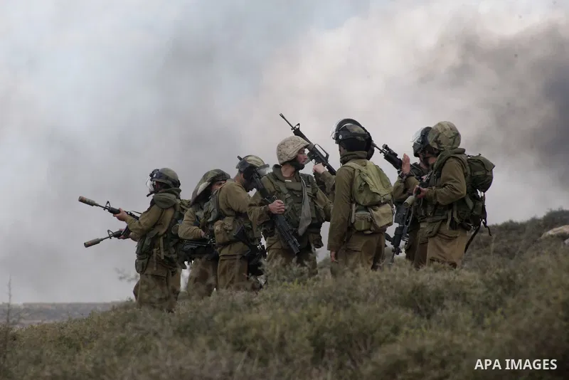 An Israeli soldier fires tear gas at Palestinian protesters during a protest against the expanding of Jewish settlement in Qusra village near the West Bank city of Nablus on Feb. 23 , 2013. Photo by Nedal Eshtayah