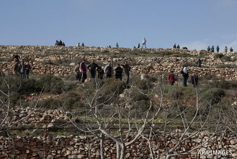 A Palestinian protestor throws stones towards Israeli soldiers during a protest against the expanding of Jewish settlement in Qusra village near the West Bank city of Nablus on Feb. 23 , 2013. Photo by Nedal Eshtayah