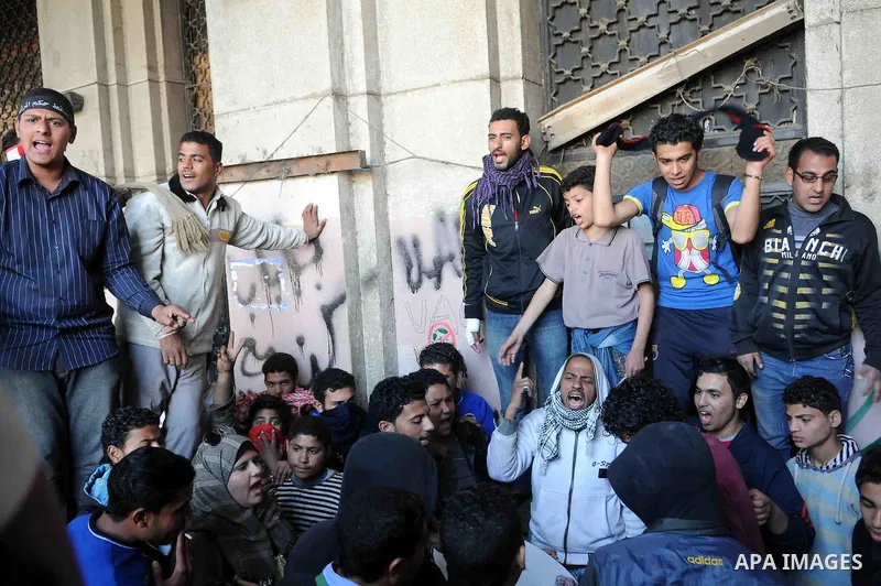 Egyptian protesters gather in front of Cairo's main administrative building on February 24, 2013, as they closed its doors part of a growing campaign of civil disobedience around the country. A group of protesters closed...