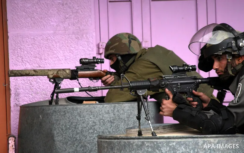 Israeli security snipers rubber at Palestinian protesters during clashes in the West Bank city of Hebron, on February 24, 2013 following the death of a Palestinian prisoner held in Israel. Some 3,000 Palestinians held in...