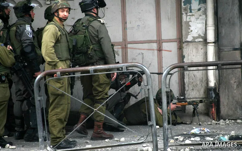 Israeli security snipers rubber at Palestinian protesters during clashes in the West Bank city of Hebron, on February 24, 2013 following the death of a Palestinian prisoner held in Israel. Some 3,000 Palestinians held in...