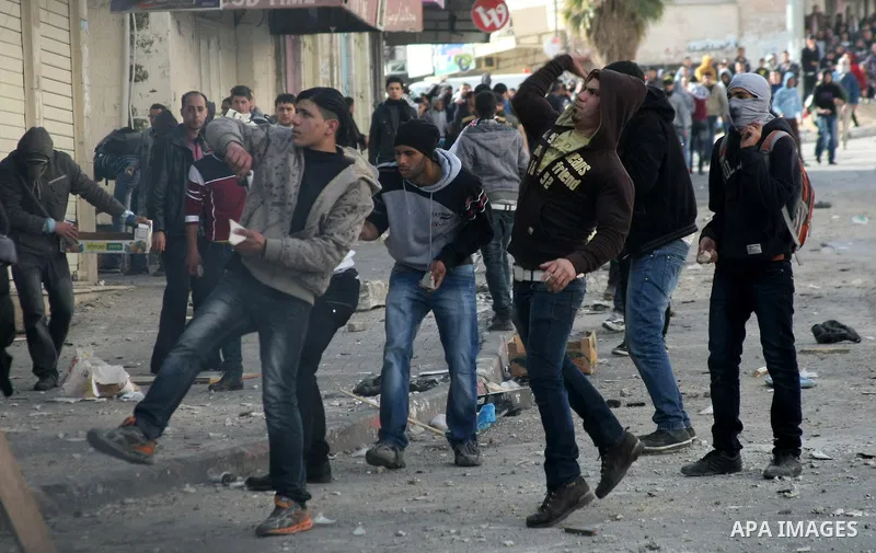 Palestinian protesters throw stones towards Israeli security forces during clashes in the West Bank city of Hebron, on February 24, 2013 following the death of a Palestinian prisoner held in Israel. Some 3,000 Palestinia...