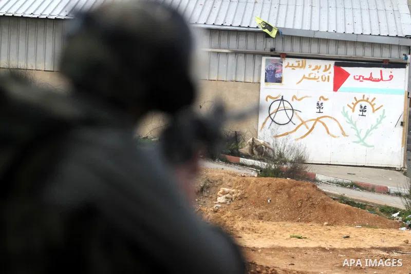 An Israeli security officer rubbers towards Palestinian protesters during clashes next to the Israeli military prison 'Ofer' in Beitunya, south of the West Bank city of Ramallah, on February 24, 2013 following the death...