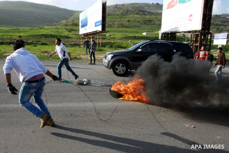 Palestinian protesters burn tires during clashes at Hawwara military checkpoint near the West Bank city of Nablus, on February 24, 2013 following the death of a Palestinian prisoner held in Israel. Some 3,000 Palestinian...