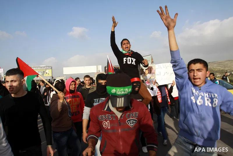 Palestinian protesters shout slogans during a demonstration at Hawwara military checkpoint near the West Bank city of Nablus, on February 24, 2013 following the death of a Palestinian prisoner held in Israel. Some 3,000...