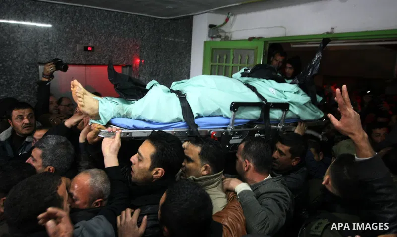 Palestinian mourners carry the body of Arafat Jaradat, a Palestinian prisoner who was killed in Israeli prison upon his arrival to the al-Ahly hospital in the West Bank city of Hebron, on February 23, 2013. The cause of...