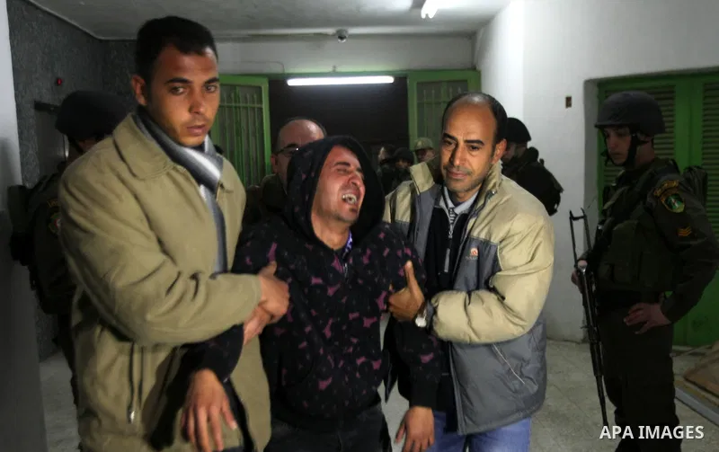 Palestinian relatives of Arafat Jaradat, a Palestinian prisoner who was killed in Israeli prison mourn upon his arrival to the al-Ahly hospital in the West Bank city of Hebron, on February 23, 2013. The cause of Jaradat'...