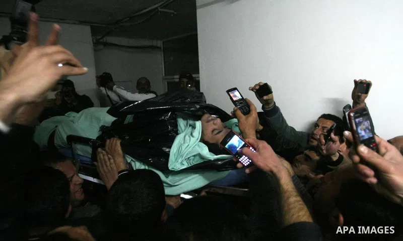 Palestinian mourners carry the body of Arafat Jaradat, a Palestinian prisoner who was killed in Israeli prison upon his arrival to the al-Ahly hospital in the West Bank city of Hebron, on February 23, 2013. The cause of...