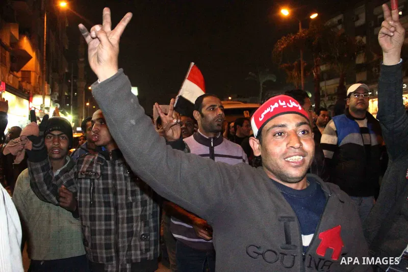 Egyptian protesters gather in front of Governorate building in Giza on February 24, 2013, as they closed its doors part of a growing campaign of civil disobedience around the country. A group of protesters closed the doo...