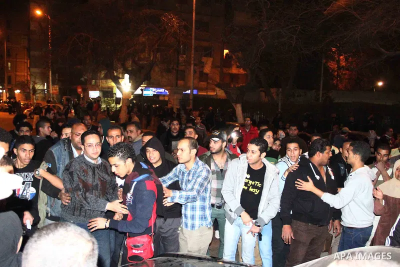 Egyptian protesters gather in front of Governorate building in Giza on February 24, 2013, as they closed its doors part of a growing campaign of civil disobedience around the country. A group of protesters closed the doo...