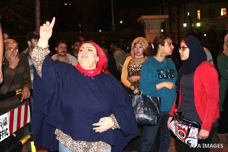 Egyptian protesters gather in front of Governorate building in Giza on February 24, 2013, as they closed its doors part of a growing campaign of civil disobedience around the country. A group of protesters closed the doo...
