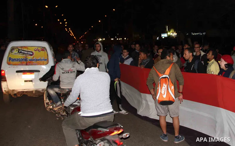 Egyptian protesters gather in front of Governorate building in Giza on February 24, 2013, as they closed its doors part of a growing campaign of civil disobedience around the country. A group of protesters closed the doo...